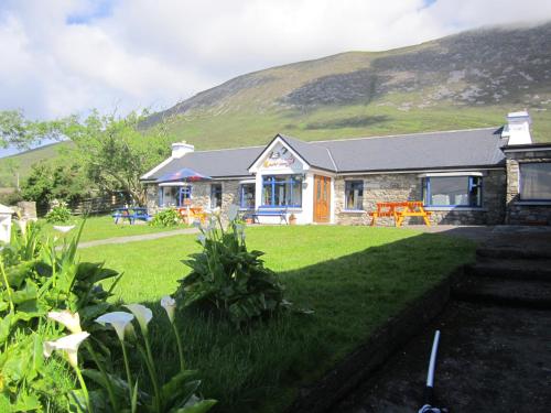 a house with a mountain in the background at Pure Magic Lodge in Slievemore