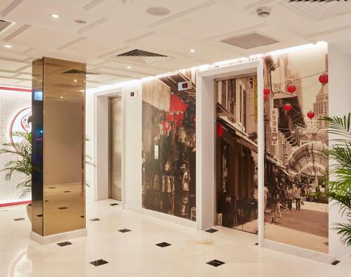 a lobby with a wall of windows with a city at Link Hotel Singapore in Singapore
