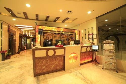 a store lobby with a counter in the middle of it at Hotel Apple Ttree in Tirunelveli