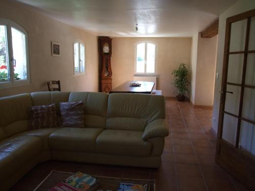a living room with a couch and a table at La Ferme de Gayri, chalet d'exception avec sauna et jacuzzi à 5 minutes de St-Lary Soulan in Vielle-Aure