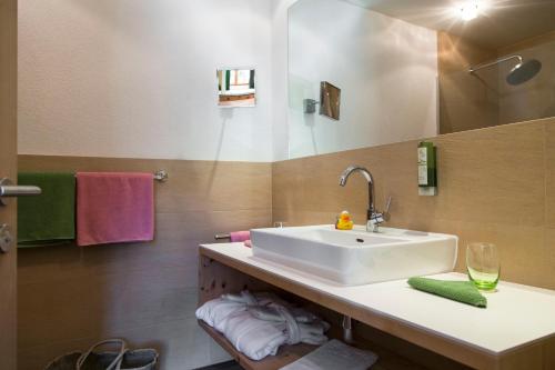 a bathroom with a white sink and a mirror at Der Waldhof in Sankt Anton am Arlberg