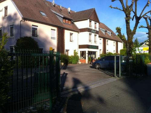 a person riding a bike in front of a house at Les Tilleuls Montbeliard Sud Audincourt in Audincourt