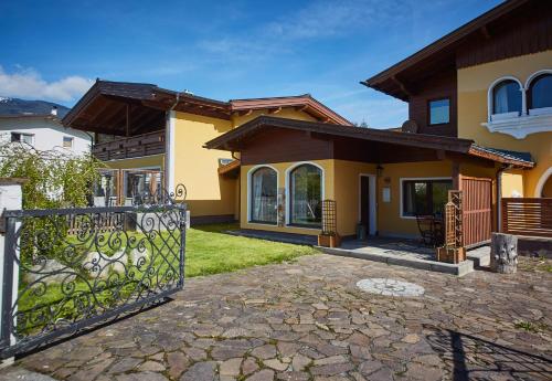 a house with a gate in front of it at M's Wood Appartement in Maishofen