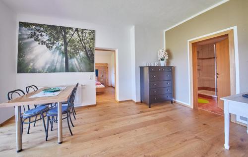 a kitchen and dining room with a table and chairs at M's Wood Appartement in Maishofen