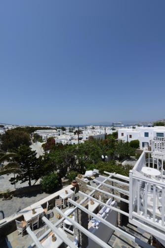a view of the beach from the balcony of a resort at Elena Hotel Mykonos in Mýkonos City