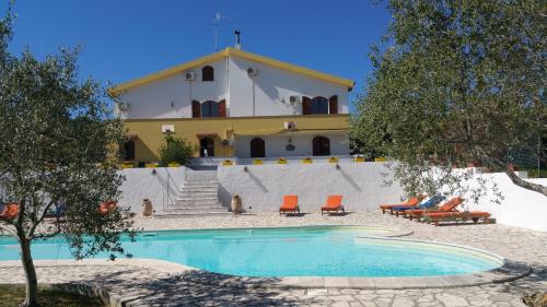 a house with a swimming pool in front of a building at Il Sogno di Alghero - Adults Only in Alghero