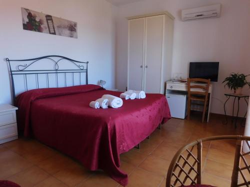 a bedroom with a bed with three towels on it at Stella Marina Sea & Sun in Cefalù