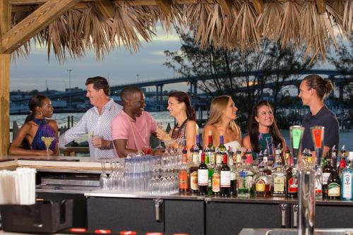 a large group of people sitting at a bar at Warwick Paradise Island Bahamas - All Inclusive - Adults Only in Nassau