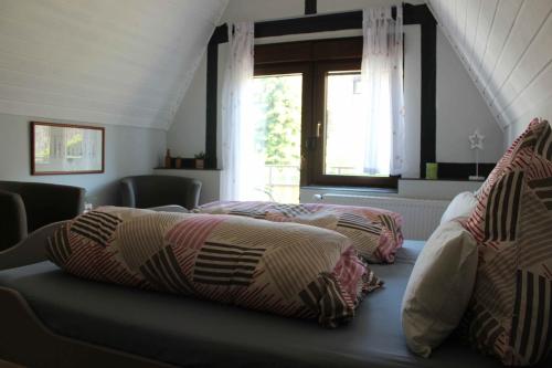 2 Betten in einem Zimmer mit Fenster in der Unterkunft Pension Rehschopp in Ediger-Eller