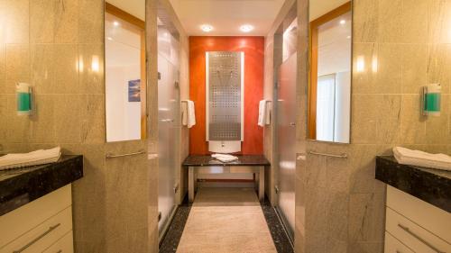 a hallway of a bathroom with a sign on the wall at Michels Strandhotel Germania in Norderney