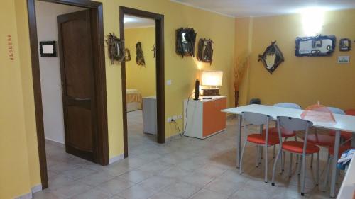 a room with a table and some chairs and a door at Il Sogno di Alghero - Adults Only in Alghero