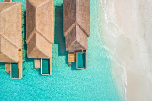 an aerial view of the ocean with beach huts at Kudafushi Resort & Spa in Raa Atoll