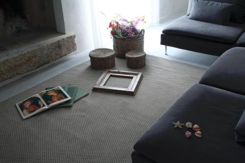 a living room with a couch and a fireplace at Dimore Santagaeta in Racale