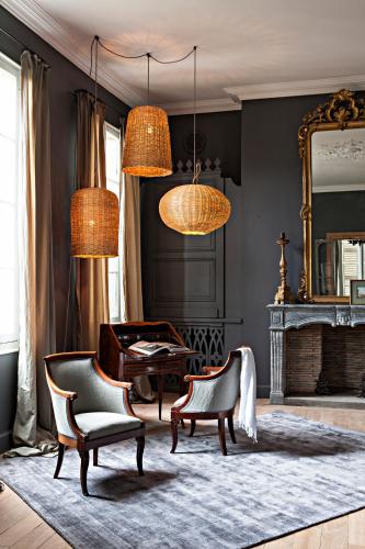 a living room with a piano and chairs and a mirror at La Divine Comédie-Suites Deluxe in Avignon