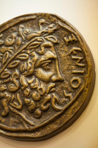 a bronze coin with a person on it at Artemision in Athens