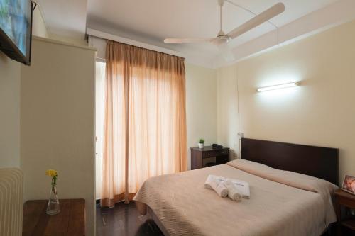 a bedroom with a bed with two towels on it at Artemision in Athens