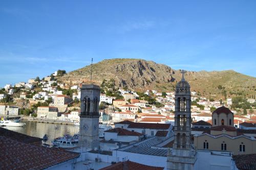 a large building with a clock tower on top of it at Pension Efie in Hydra