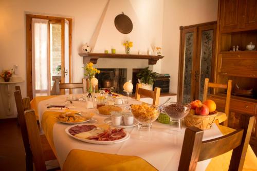 a table with plates of food on top of it at B&B Vista Casentino in Pratovecchio