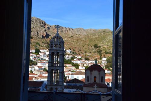a tower with a clock on top of it at Pension Efie in Hydra