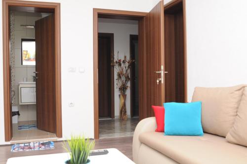 a living room with a couch and a mirror at Vila Magdalena in Gevgelija
