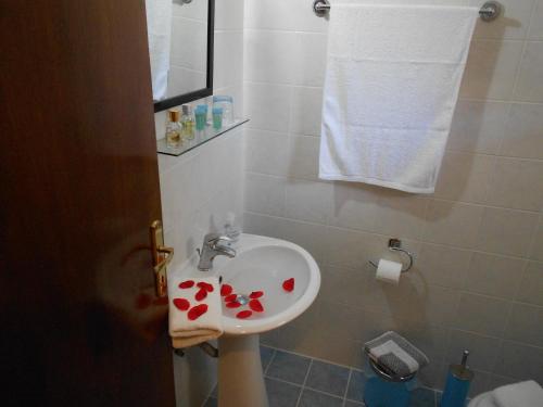 a bathroom with a sink with hearts on it at House Georgia in Kallithea Halkidikis