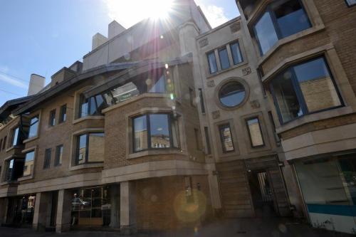 a large brick building with the sun shining on it at Christ's College Cambridge in Cambridge