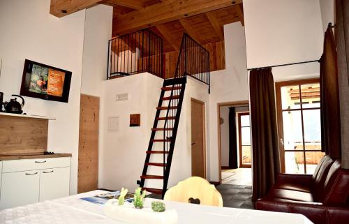 a kitchen with a spiral staircase in a house at Putzerhof in Funes