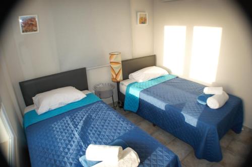 a bedroom with two beds and a window at Periyiali Beach Sunset Suite A7 in Pervolia