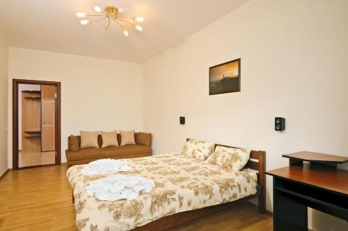 a bedroom with a bed and a couch at Lukyanovsky in Kyiv