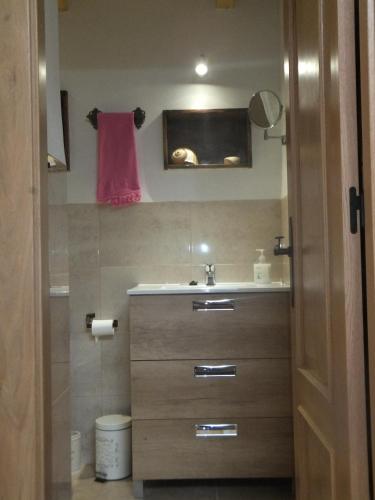 a bathroom with a sink and a pink towel at La Limonera in Riópar