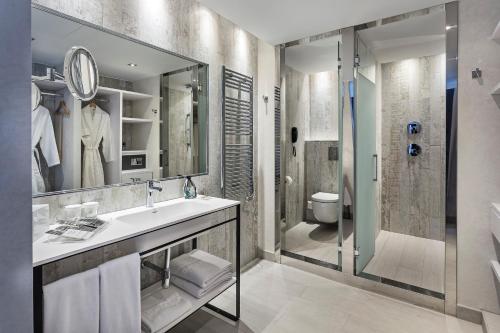 a bathroom with a sink and a shower at Catalonia Royal Ses Estaques-Adults Only in Santa Eularia des Riu