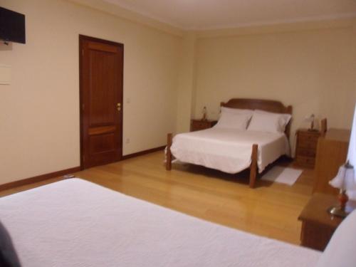 מיטה או מיטות בחדר ב-Casa Da Veiga