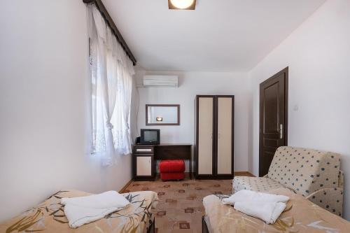 a living room with a couch and a chair at Къща за гости "При Примо" in Zlatograd