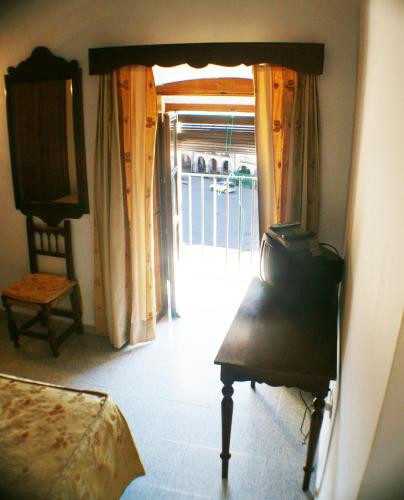 a room with a door leading to a balcony at Hostal Meson la Cadena in Trujillo