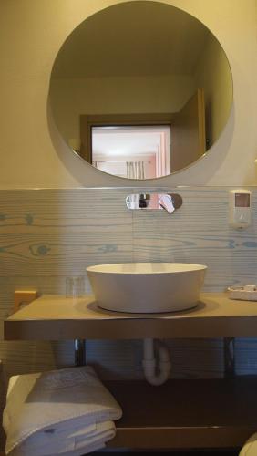 a bathroom with a sink and a mirror at Piccolo Hotel in Moneglia