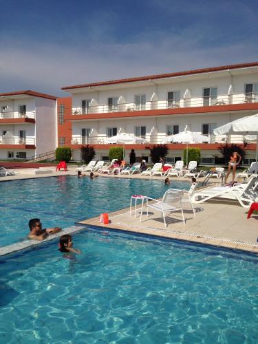 two people in the swimming pool of a hotel at Athina Airport Hotel in Thérmi