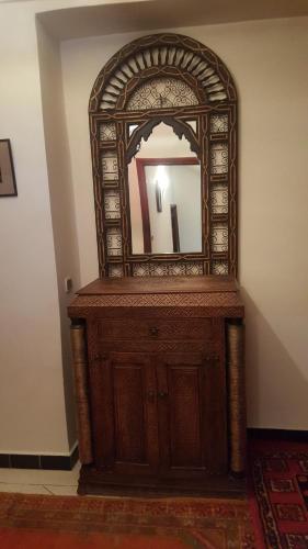 a wooden dresser with a mirror on top of it at Riad Villa Midelt in Midelt