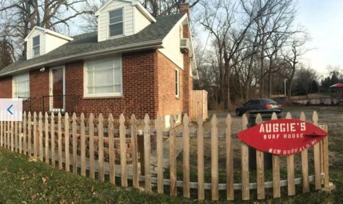 a house with a wooden fence in front of it at Walking Distance To Beach And Shops in New Buffalo