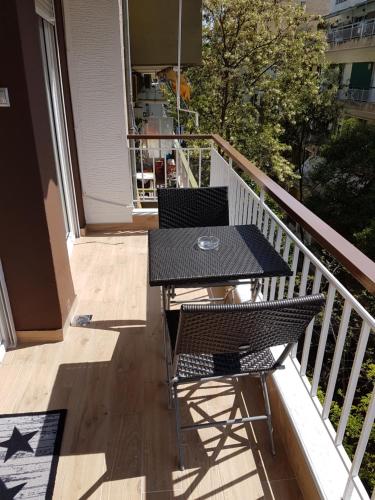 a black table and chairs on a balcony at Route 77 in Thessaloniki