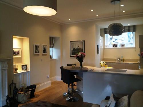 a kitchen with a island in the middle of a room at Carbet Lodge in Dundee