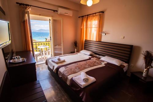 sypialnia z dużym łóżkiem i dużym oknem w obiekcie Ulrika w mieście Egina
