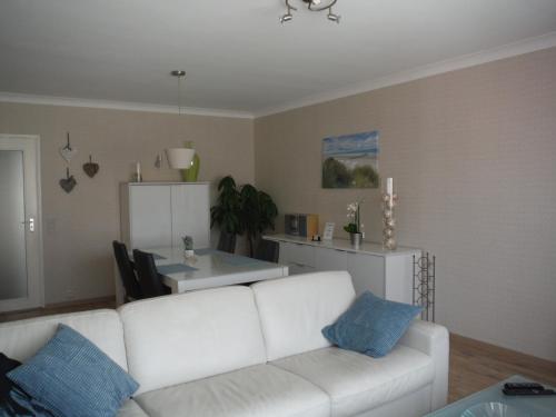 a living room with a white couch and a table at Apartments Iris in Ostend