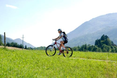 a person riding a bike in a field at EurothermenResort Bad Ischl - Hotel Royal 4-Sterne Superior in Bad Ischl