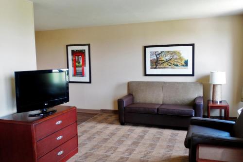 a living room with a couch and a flat screen tv at Extended Stay America Suites - Phoenix - Chandler - E Chandler Blvd in Phoenix
