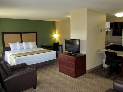 a hotel room with a bed and a flat screen tv at Extended Stay America Suites - Phoenix - Chandler - E Chandler Blvd in Phoenix