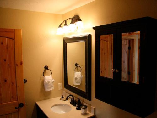 a bathroom with a sink and a mirror at Montana Style Downtown Condo in Whitefish