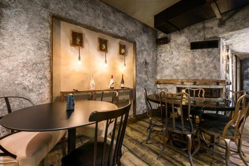 a restaurant with two tables and chairs and a fireplace at Elakati Luxury Boutique Hotel - Adults Only in Rhodes Town