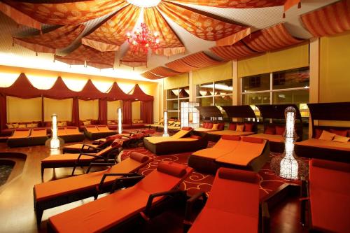 a large room with chairs and tables and a ceiling at EurothermenResort Bad Ischl - Hotel Royal 4-Sterne Superior in Bad Ischl