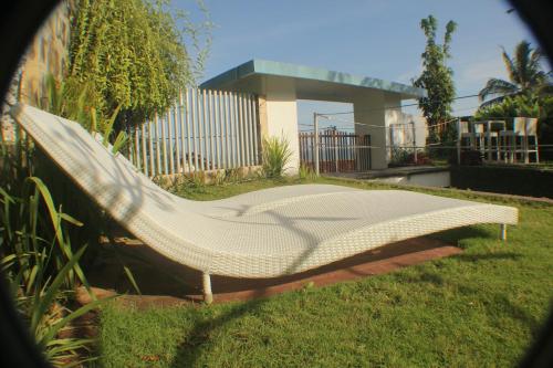 a hammock in the grass in front of a house at Villa Alcheringa Parangtritis in Parangtritis