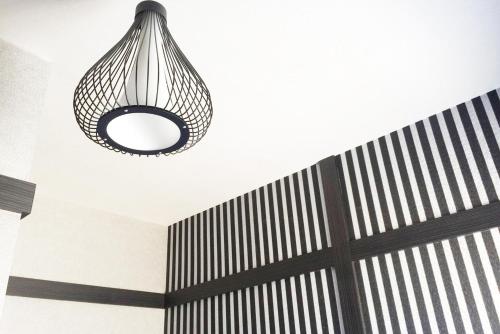 aendant light hanging from a ceiling in a room at Hananoi Bed and Breakfast in Hengchun